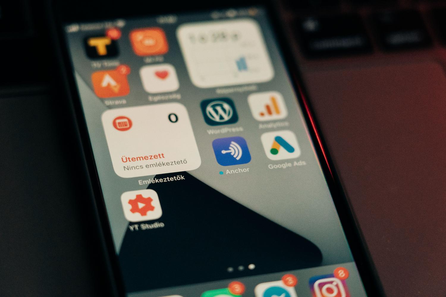 Close-up of a smartphone screen displaying various app icons including advertising and analytics tools