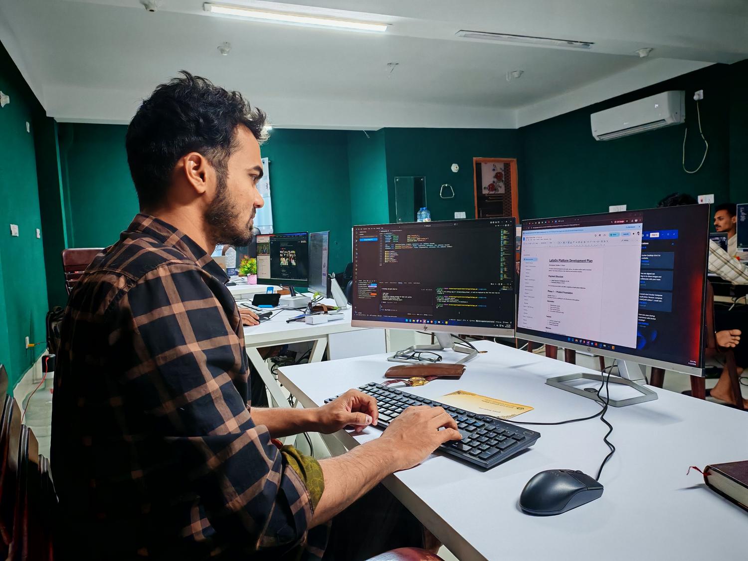 Desarrollador de software trabajando en código en un entorno de oficina moderno con doble monitor, ideal para la sección de herramientas pro-code.