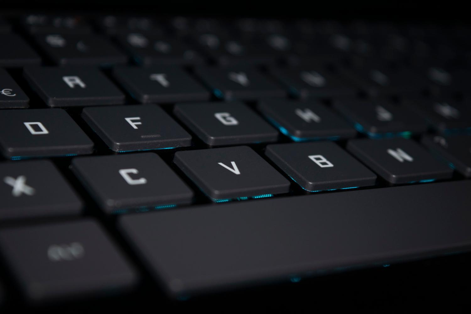 Teclado retroiluminado en ambiente oscuro, ideal para ilustrar restricciones avanzadas y entornos de sistemas IoT.