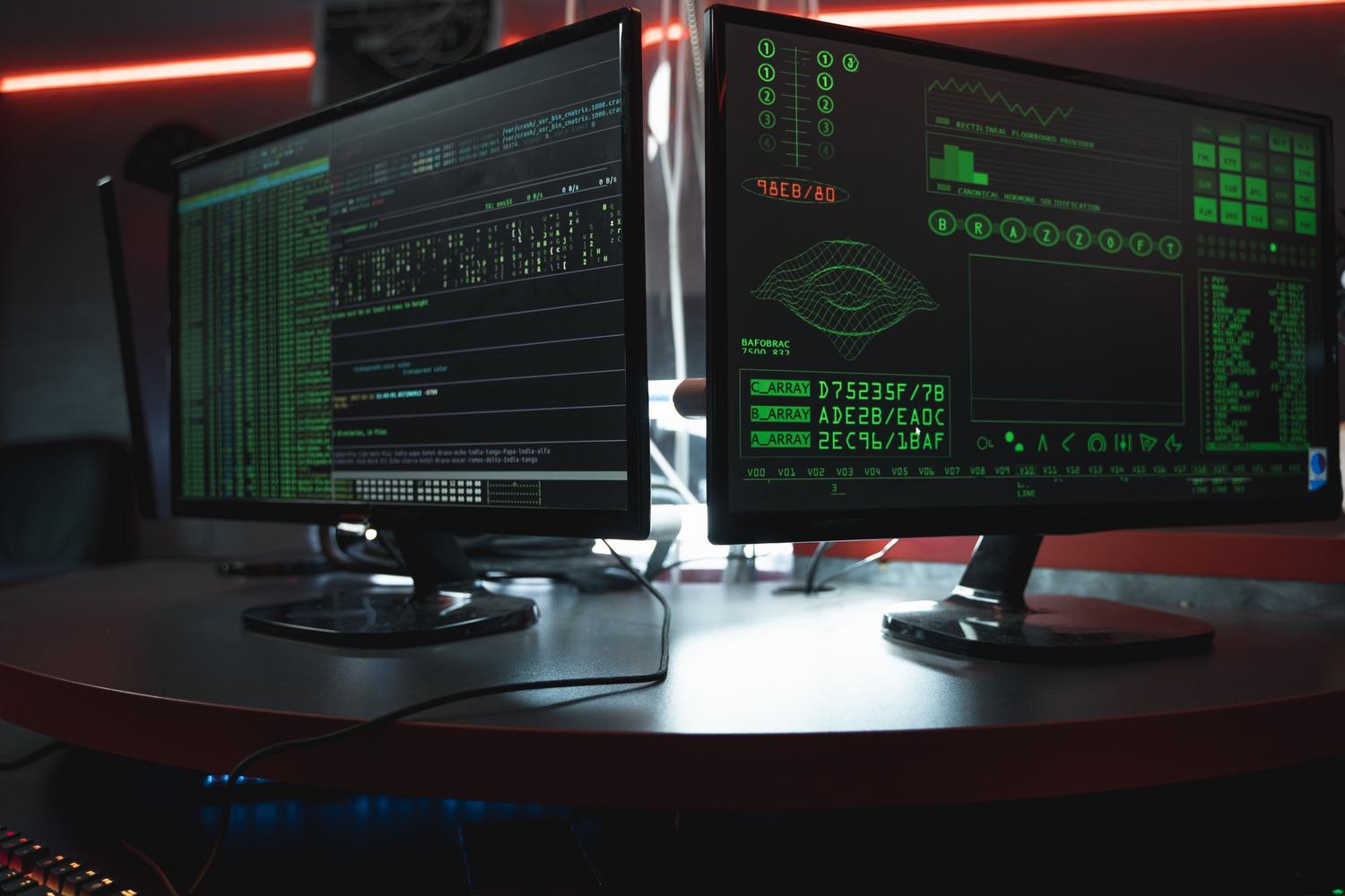 Pantallas de ordenador con interfaces de monitorización de datos y código en un entorno oscuro, ideal para ilustrar el diagnóstico de software.