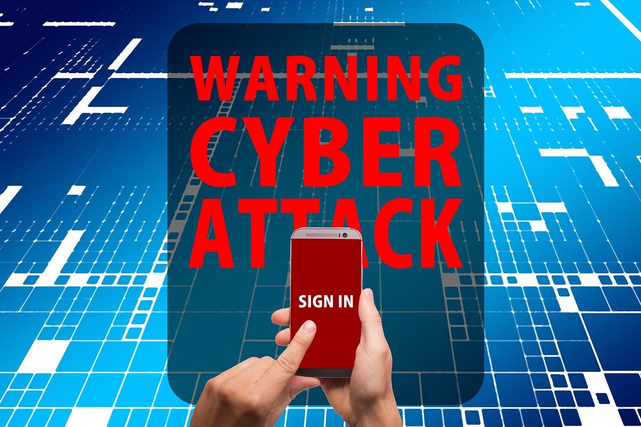 Alerta de ciberataque en la pantalla de un smartphone con un botón de inicio de sesión, ilustrando el phishing y la suplantación de identidad.